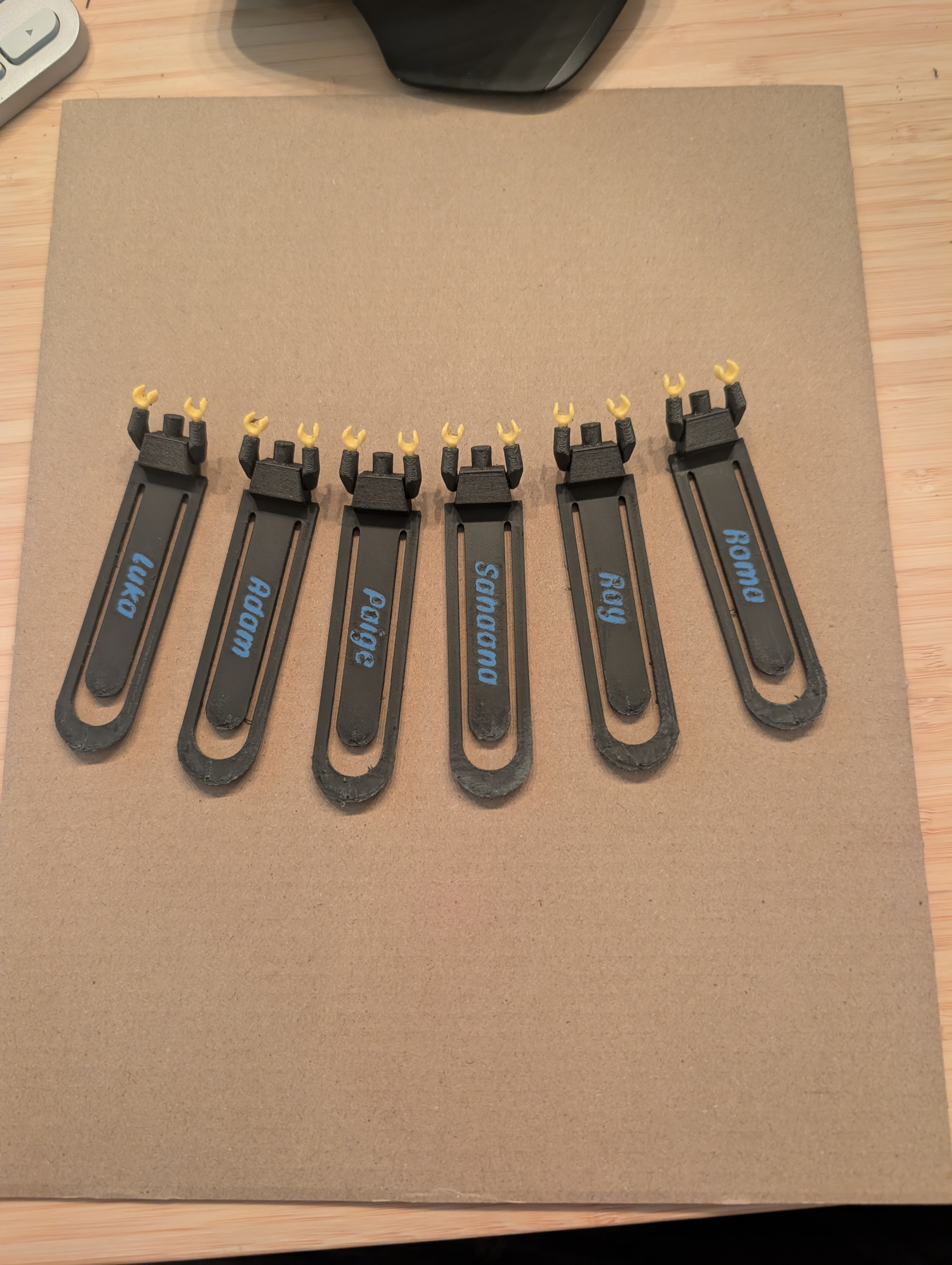 3D-printed Lego bookmarks, each with a different name printed on it